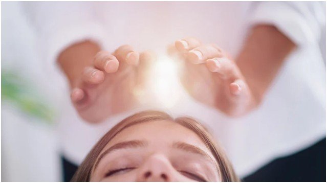 How does energy healing claim to work in traditional practice?